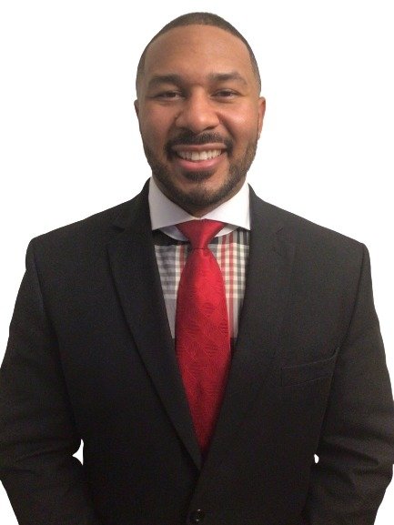Aaron Terrell Webb, founder of Webb's Enterprises, in a dark suit and red tie